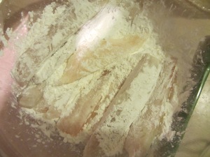 Dredging fish in cornstarch.