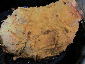 Mustard brushed all over ham.