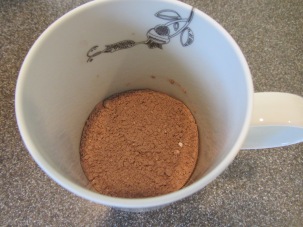 Mug, 1/3 full of cocoa mix.