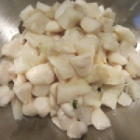 Fish and scallops, after marinating and being drained.
