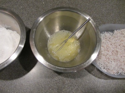 Three containers for coating shrimp: cornstarch mixture, egg whites, and coconut.