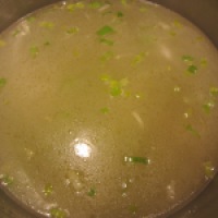 Chicken stock added to leeks.