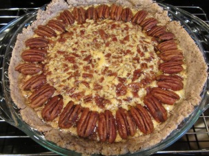 Pie, adorned with spiced pecans, and placed back into the oven.