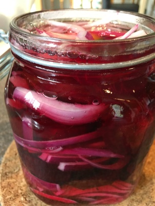 Boiling brine poured over beets and onions.