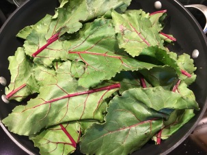 Beet greens added to the pan.