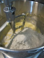 Half of the dry ingredients being added to the batter.