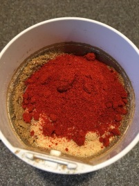 Chili powder, onion powder, and paprika added to spice grinder.