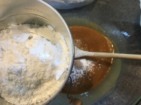Powdered sugar being sifted in.