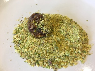 Fruit ball, rolling in ground pistachios.