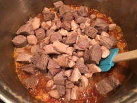 Meat added to chili.