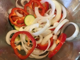 Zucchini, red bell pepper, onion, and garlic tossed with olive oil.