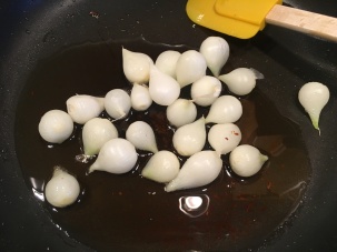 Pearl onions added to pork fat.