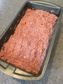 Meat mixture placed in loaf pan.