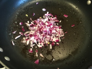 Red onion added to bacon fat.