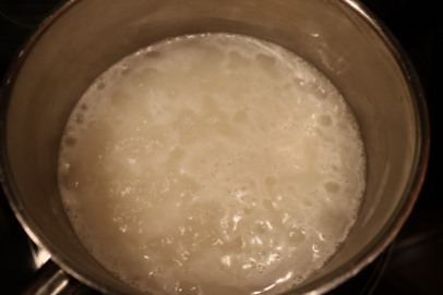 2 C of rice in a saucepan with 2 C water and brought to a boil over high heat.