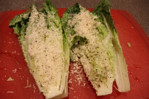 Romaine hearts after dipping/pressing into grated Parmesan.