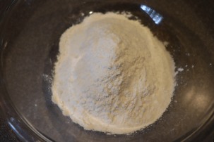 Chilled shortening in a bowl with flour mixture on top.