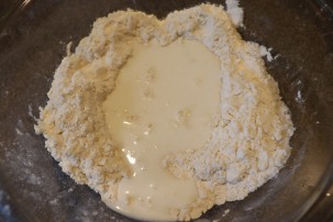 Milk poured into well of dry ingredients.
