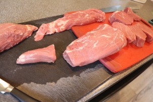 Butchered tenderloin. The meat in the upper left is the head muscle that is for a stuffed roast. Below that is meat for carpaccio. The meat at the top of the picture is the chain for cheesteaks. Below that is a center cut roast. Then you have the four filets.