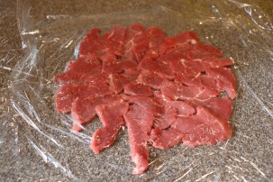 Meat topped with plastic.