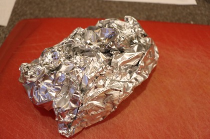 Seared chain wrapped in foil to rest.