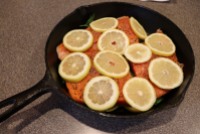 More lemon placed on top of fish.